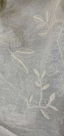 Delicate leaf and sprig embroidery on translucent fabric.