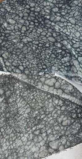 A grey crackle-resist texture across draped fabric.