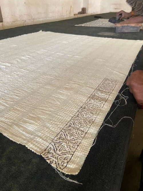 Cream fabric on the table with a freshly printed geometric border.