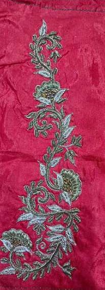 A long metallic vine embroidered on red silk.
