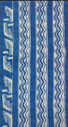 Indigo stripes with a printed border of small figures.