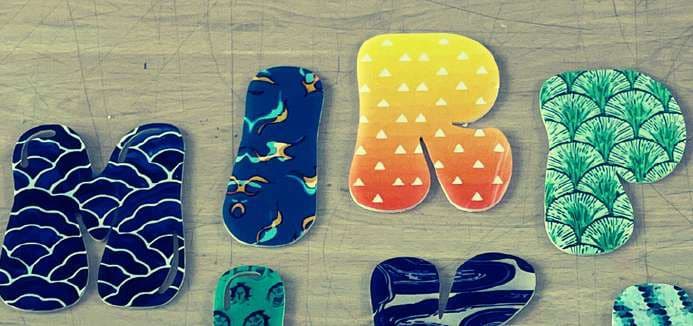 A row of fabric letters in wave, gradient and ogee prints.