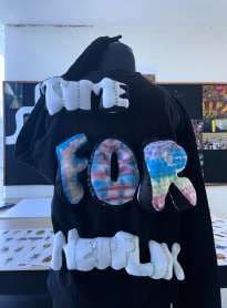 The back of a black hoodie with puffed letters reading TIME FOR NETFLIX.