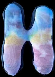 A puffed, tie-dyed fabric letter H.