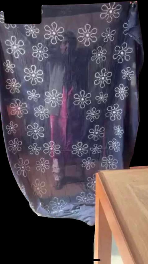Light indigo cloth with scattered white flower resists.