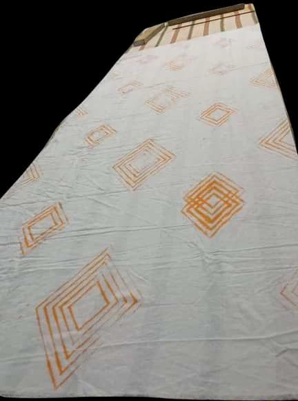 Cloth marked with orange stitched diamond outlines.