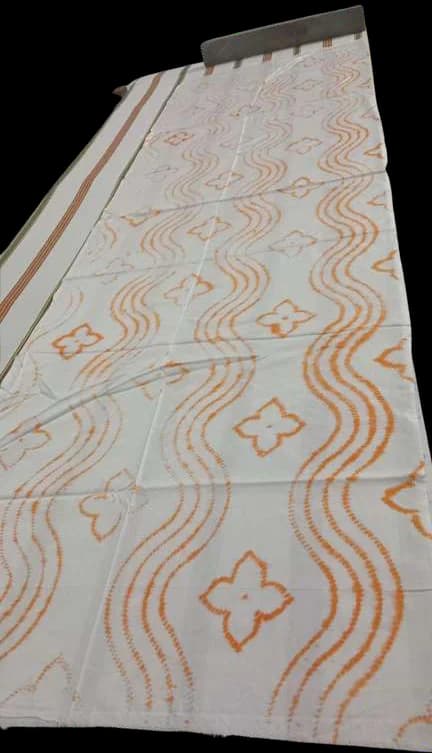 Rows of wavy orange stitch lines across a length of cloth.
