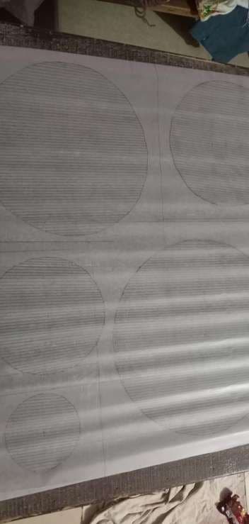 Pale cloth pleated and compressed, faint circles showing through.