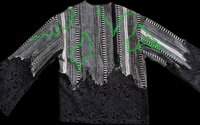 A top joining striped woven fabric to black lace, traced with green stitch lines.